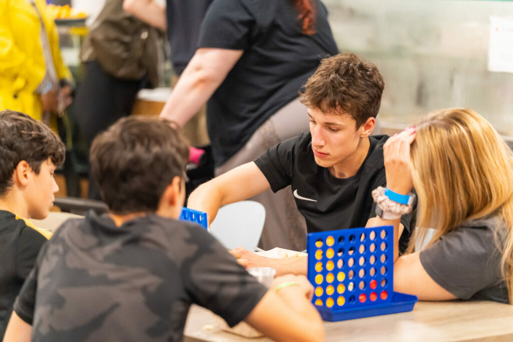 Young people playing Connect Four at Youth Connect '25
